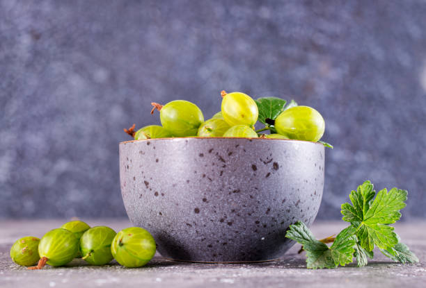 Fresh gooseberry in gray bowl on a table