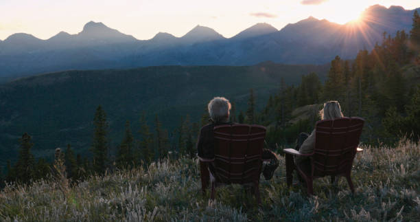 istock Mature couple watch sunset over mountains 2171371206