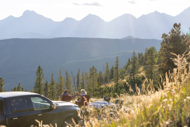 Mature women enjoy picnic on mountain meadow