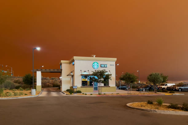 Hesperia, CA, USA - September 10, 2024: Smoke from brush fires in the Southern California Mountains creates a orange sky in the Mojave Desert.