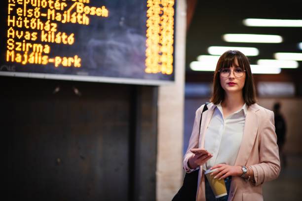 istock Woman talking on phone at train station terminal 2171374964