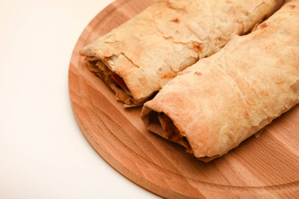 Meat shawarma on a cutting board. Burritos with meat.