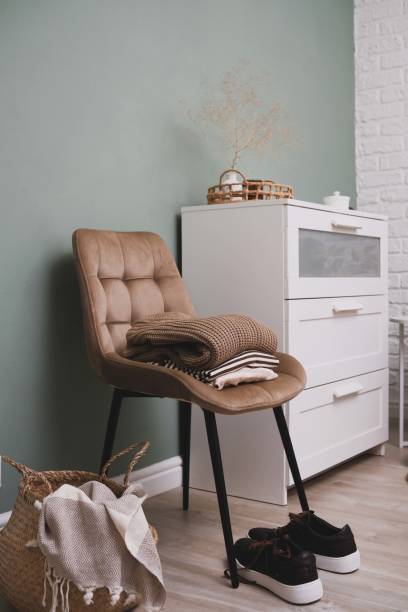 istock A stylish and cozy corner featuring a comfortable chair alongside essential clothing items 2171378511