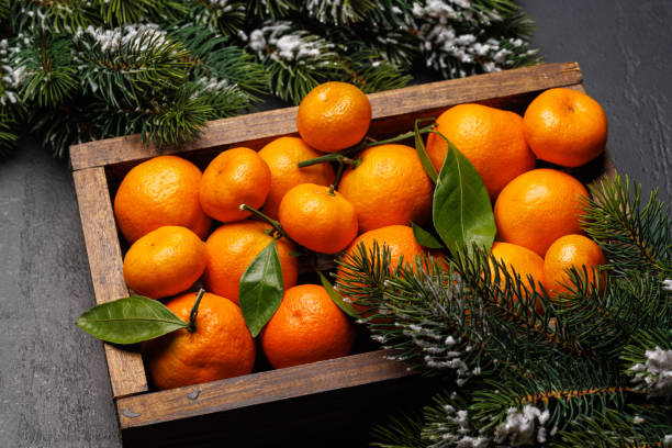 istock Festive citrus joy: Tangerines in a holiday-themed box 2171379156