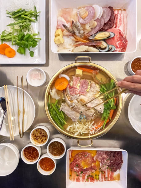 istock Iron pan for barbecue grill with hot pot making at the same time. Fresh ingredients, meats, and sauces ideal for sharing among friends and family. 2171380648