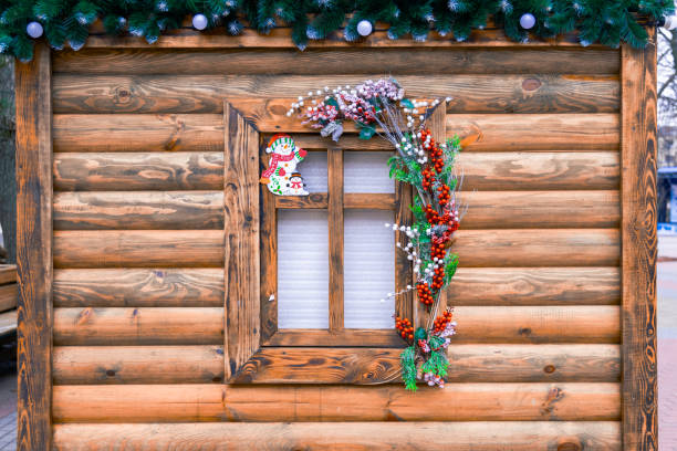 external Christmas eve rural wooden decorative cabin frame work with window and wreath element colorful December season holidays time concept image