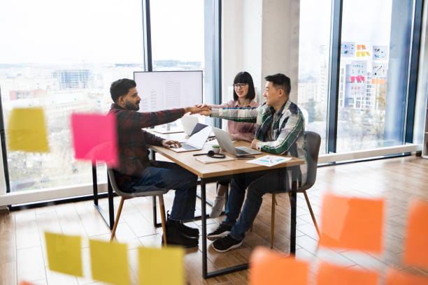 istock Architects brainstorming in modern office with large windows 2171383143