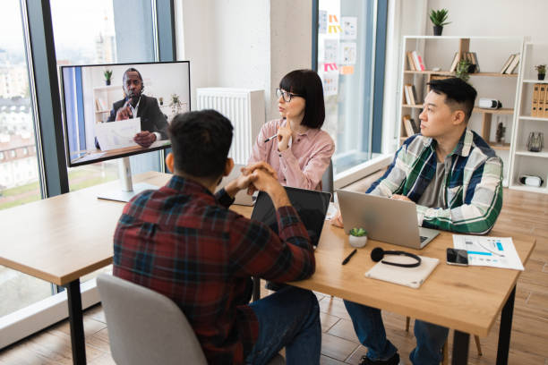 istock Team participating in video conference meeting at modern office 2171383164