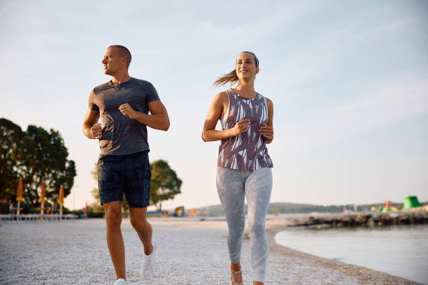 istock Young happy athletes running on the beach. 2171383981