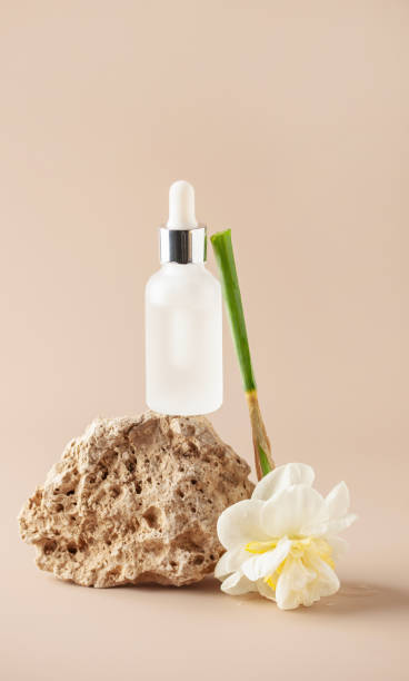 istock Cosmetic serum bottle on travertine stone podium. Minimal mockup background. 2171384968