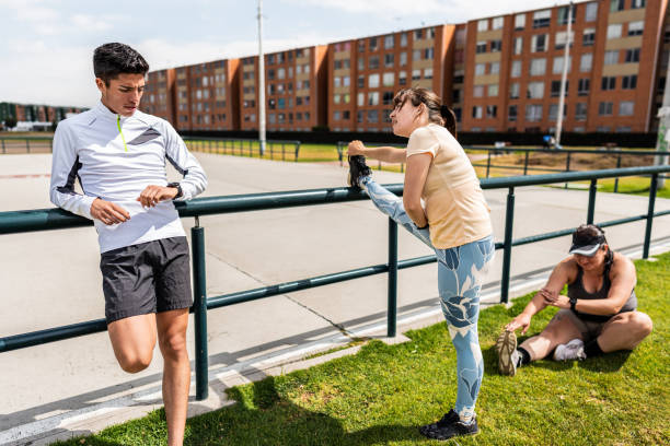 Friends talking and stretching outdoors