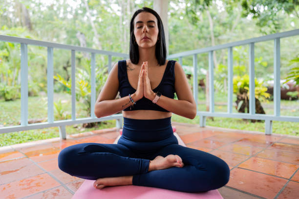 istock Young woman practicing yoga in a nature reserve 2171387332