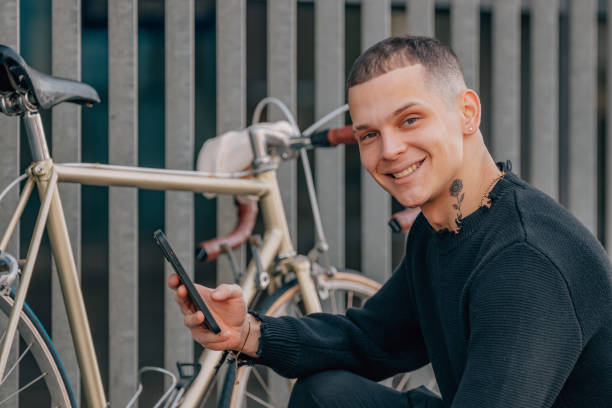 istock young man with bicycle on street 2171388800