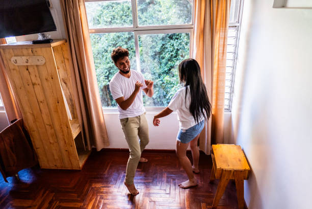 istock Young couple dancing on hotel room 2171389159
