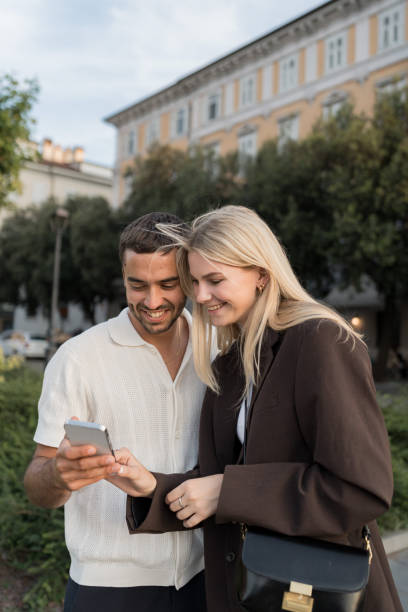 istock Young, upscale couple look at mobile phone together 2171390993
