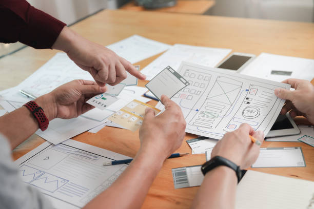 istock UX or UI designers designing on digital tablet and smartphone application layout prototype project. 2171393263