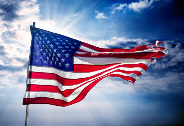 istock Close up American flag over dramatic sky 2171400071