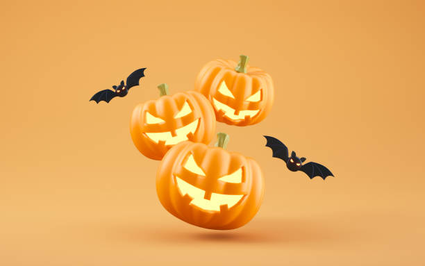 istock Jack-o-Lantern pumpkins and bats on orange background 2171400959