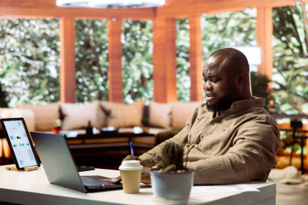 istock Freelancer writing business reports and managing finance on his laptop 2171401084