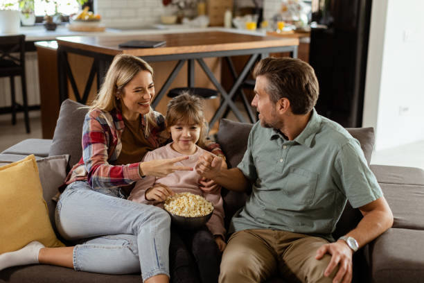 istock Cozy family time: sharing laughter and popcorn on a casual evening 2171406603