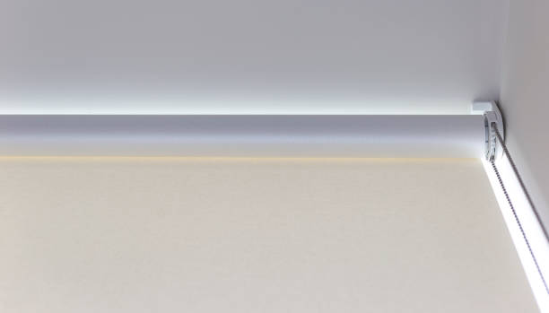 istock Simple white window treatment with roller shade and natural light illuminating the interior space 2171407139