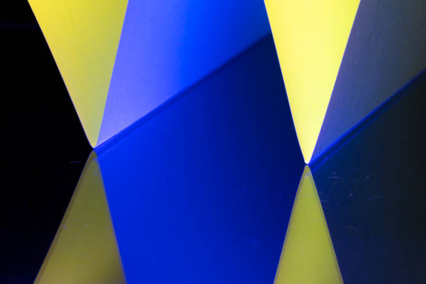 Sharp angles and vivid hues in different blue and yellow tints with black combine to form a captivating abstract composition, showcasing the beauty of geometry in art. The striking contrasts draw viewers into the vibrant interplay of colors.
