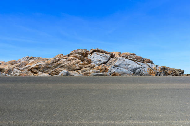 Asphalt road and rock with sky