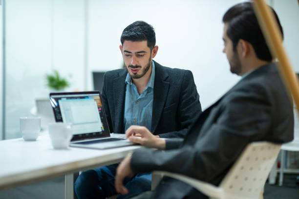 istock men reviewing company statistics 2171419572