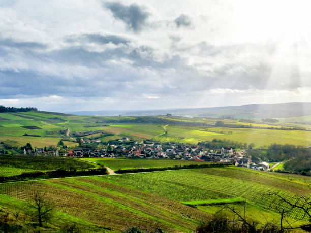 istock Small town in green rolling landscape over dramatic sky 2171429432
