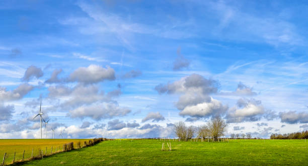Wind turbines over sunny sky in nature of Sainte-Magnance, France