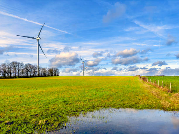 Wind turbines over sunny sky in nature of Sainte-Magnance, France