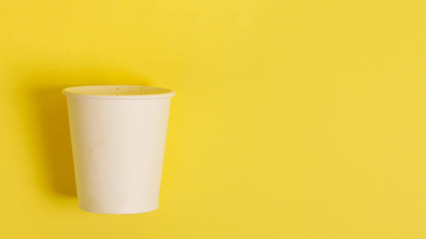 istock Disposable paper cup for coffee and tea on a bright orange background. 2171430020