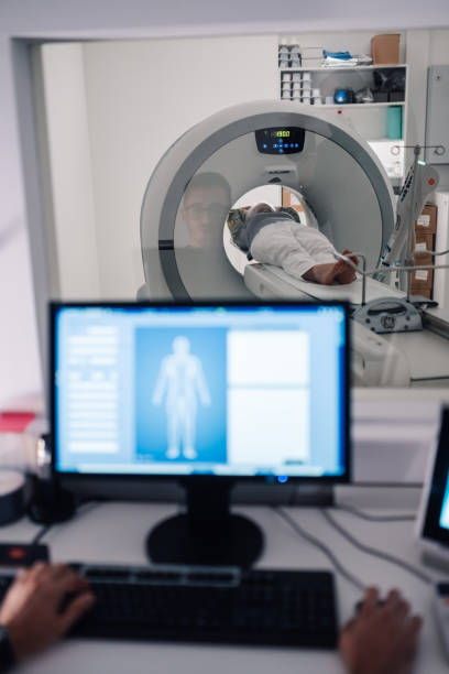 istock Technician conducting a CT scan while monitoring from screen. 2171430181