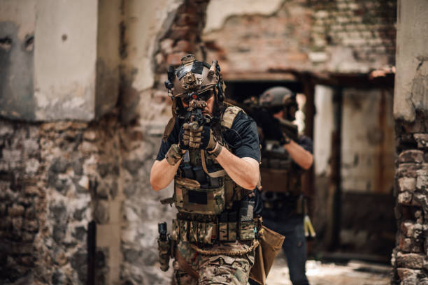 istock Front view of infantryman aiming with sniper rifle towards camera, 2171430198