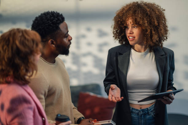 istock Businesswoman with tablet explaining innovative project to diverse staff 2171430290