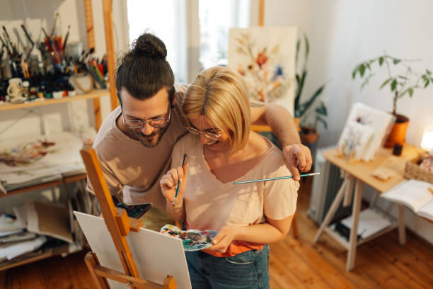 istock Romantic artistic couple hugging and painting together at art studio. 2171430295