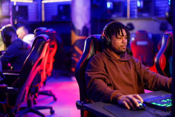istock A multicultural gamer with headset playing a moba game in cybercafe. 2171430314