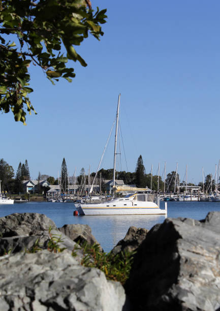 istock Boat at a marina with rocks in the foreground 2171434473
