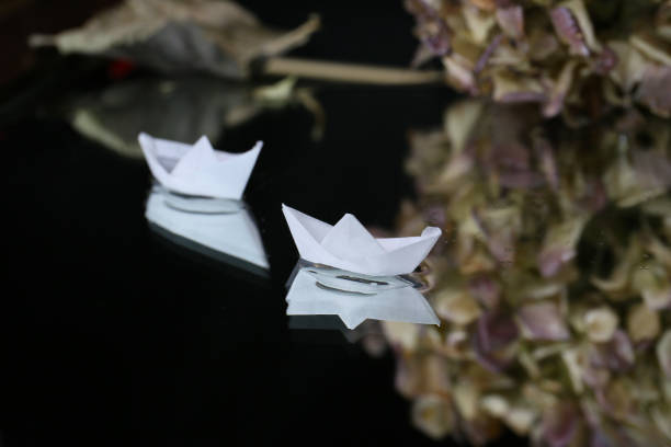 istock artistic still life with tiny origami boats on a dark background 2171435962