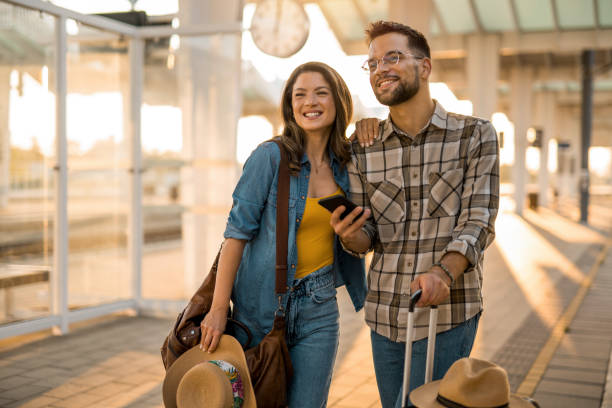 istock Young couple at train station. 2171436473