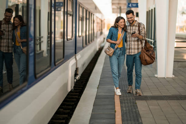 istock Young couple at train station. 2171436845