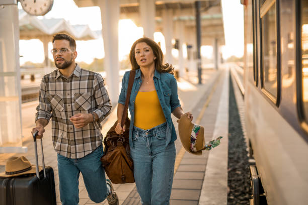 istock Young couple running late for their train. 2171437268