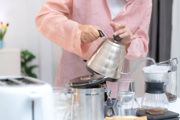 istock Asian young woman enjoying bread and coffee for breakfast at home, morning routine before work 2171437318