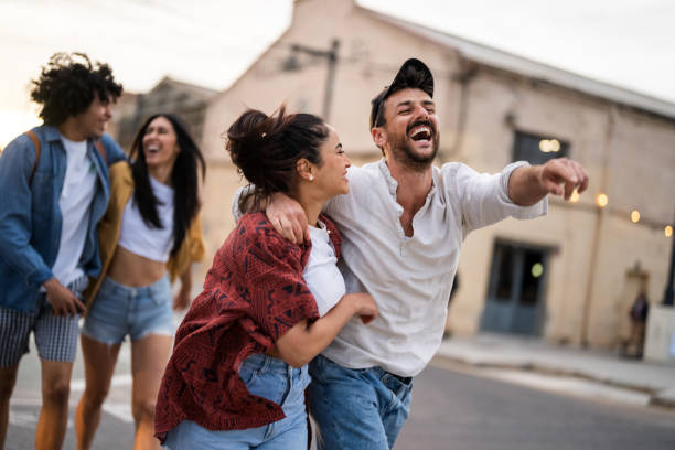 istock Joyful Couples Enjoying a Stroll in Urban Setting 2171439768