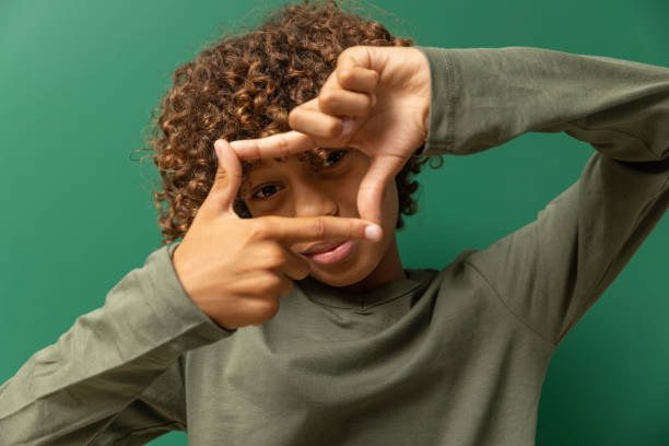 istock Beautiful young black boy posing for studio portrait 2171441181