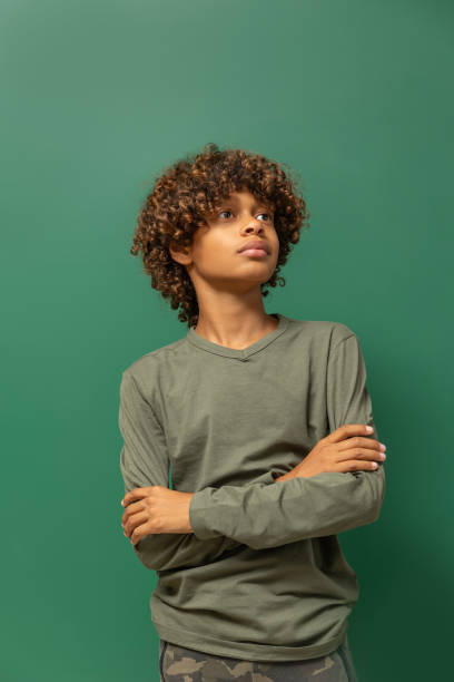 istock Beautiful young black boy posing for studio portrait 2171441259