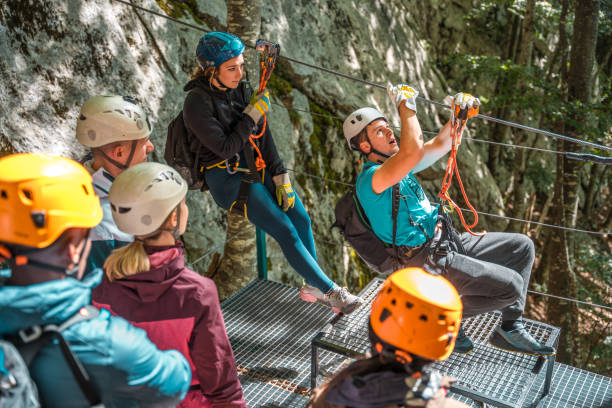 istock Young Experienced Zipline Instructor Demonstrating Finesse And Skill Ensuring Each Participant Feels Empowered And Ready For Exhilarating Flight 2171442711