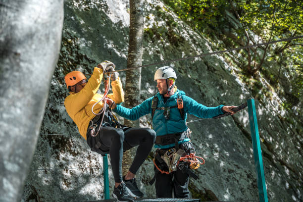 istock Experienced Zipline Instructor Showcasing Safety Instructions For A Young Black Adventurer Before Gliding 2171442726