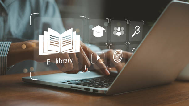 istock E-library concept. Person use laptop with virtual E-book icons for electronic books online, knowledge base on internet, digital library or e-library. Internet e-learning lessons and online 2171443036