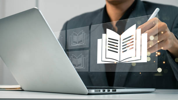 E-library concept. Person use laptop with virtual E-book icons for electronic books online, knowledge base on internet, digital library or e-library. Internet e-learning lessons and online